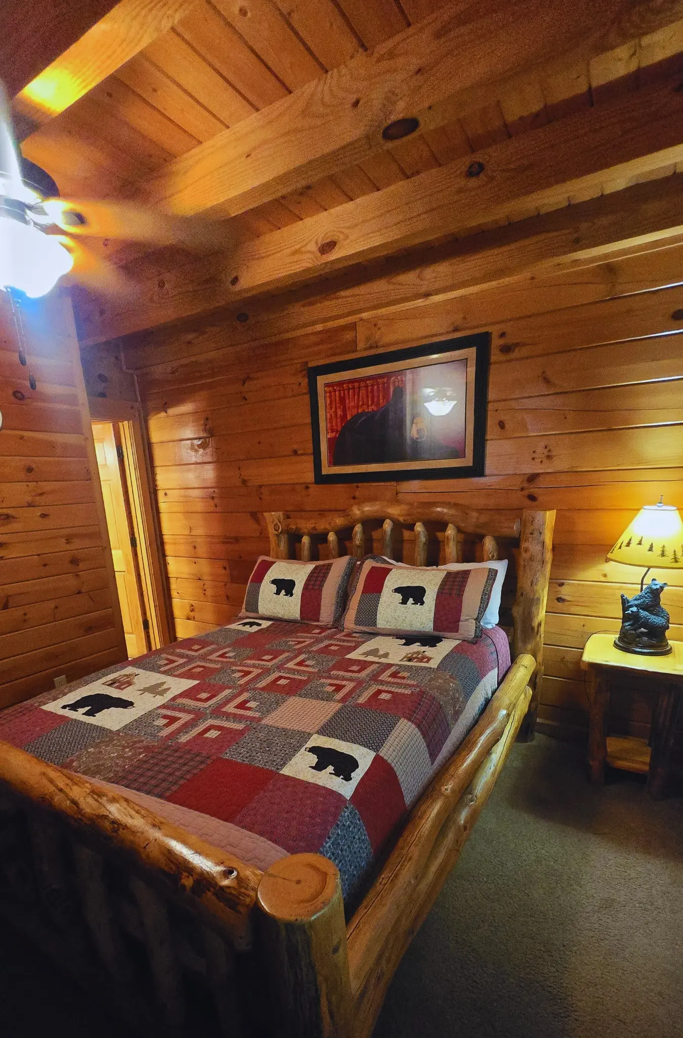 Wood-paneled bedroom with traditional log bed at Heavenly Heights