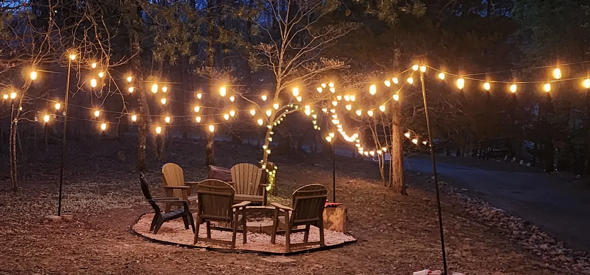 Glowing café lights over the outdoor seating area at night