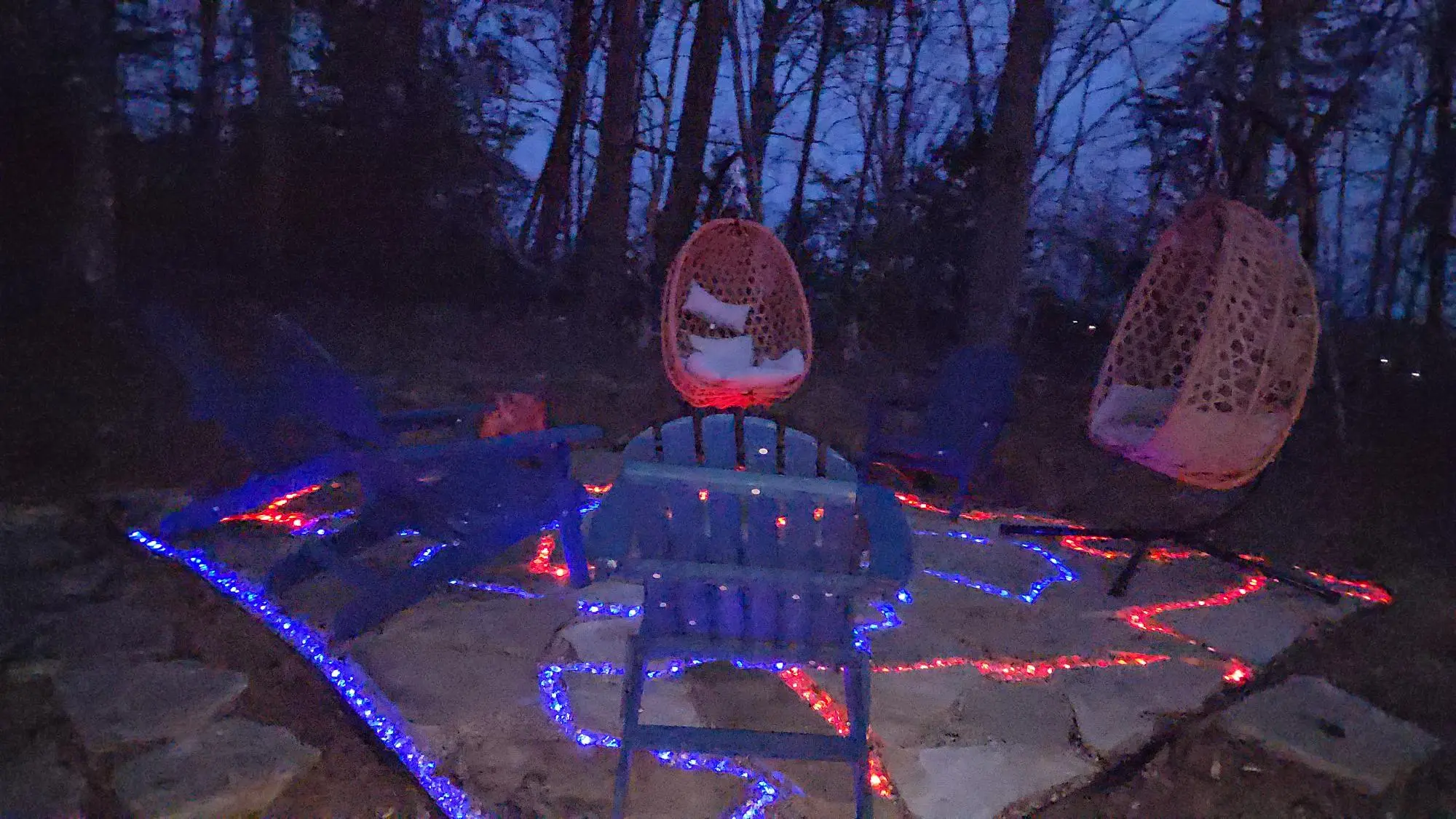 Hanging egg chairs illuminated at night