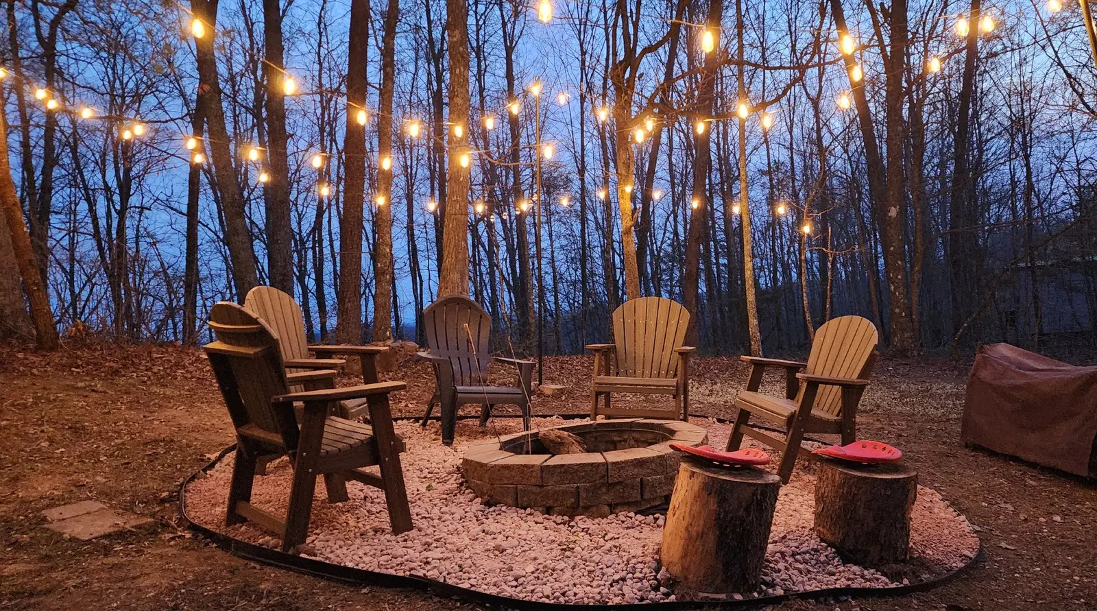 Adirondack seating around the fire pit at dusk