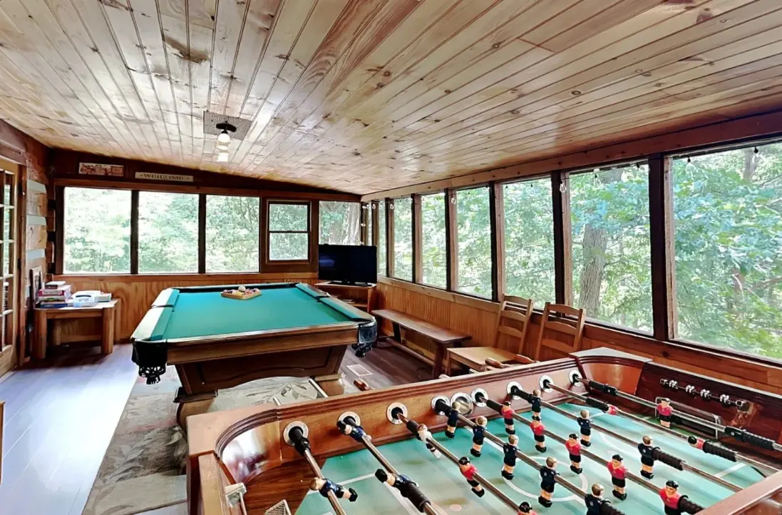 Bright game room with pool table and foosball at Peaceful Ridge